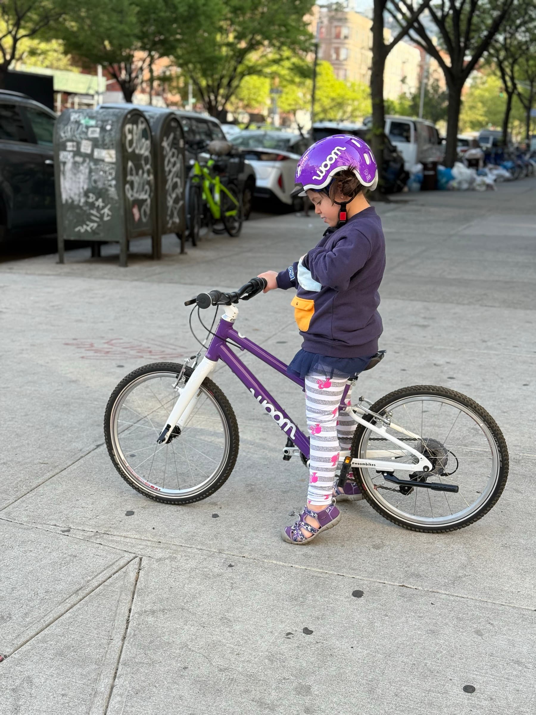 One of Maddy's kids riding a bike on the sidewalk