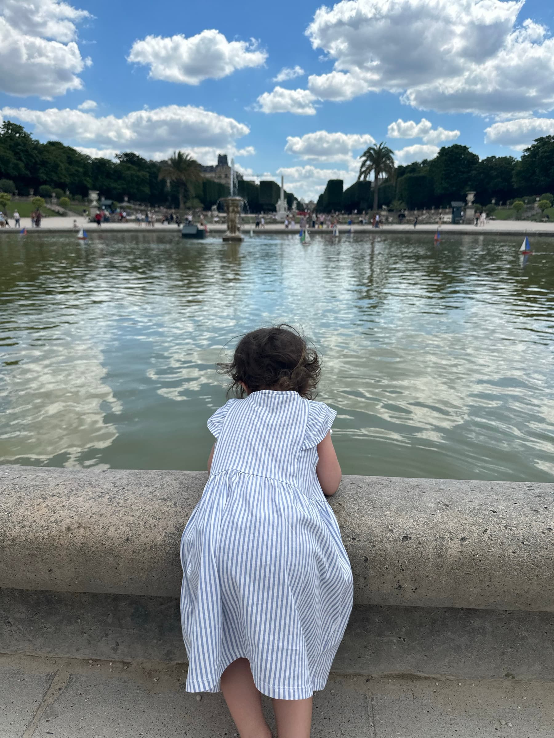 One of Maddy's kids looking out over a pond in a European park